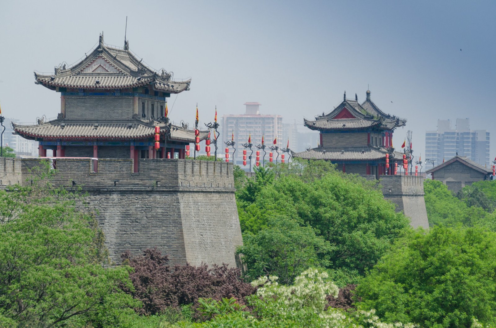 Xi'an city wall with traditional watchtowers and greenery