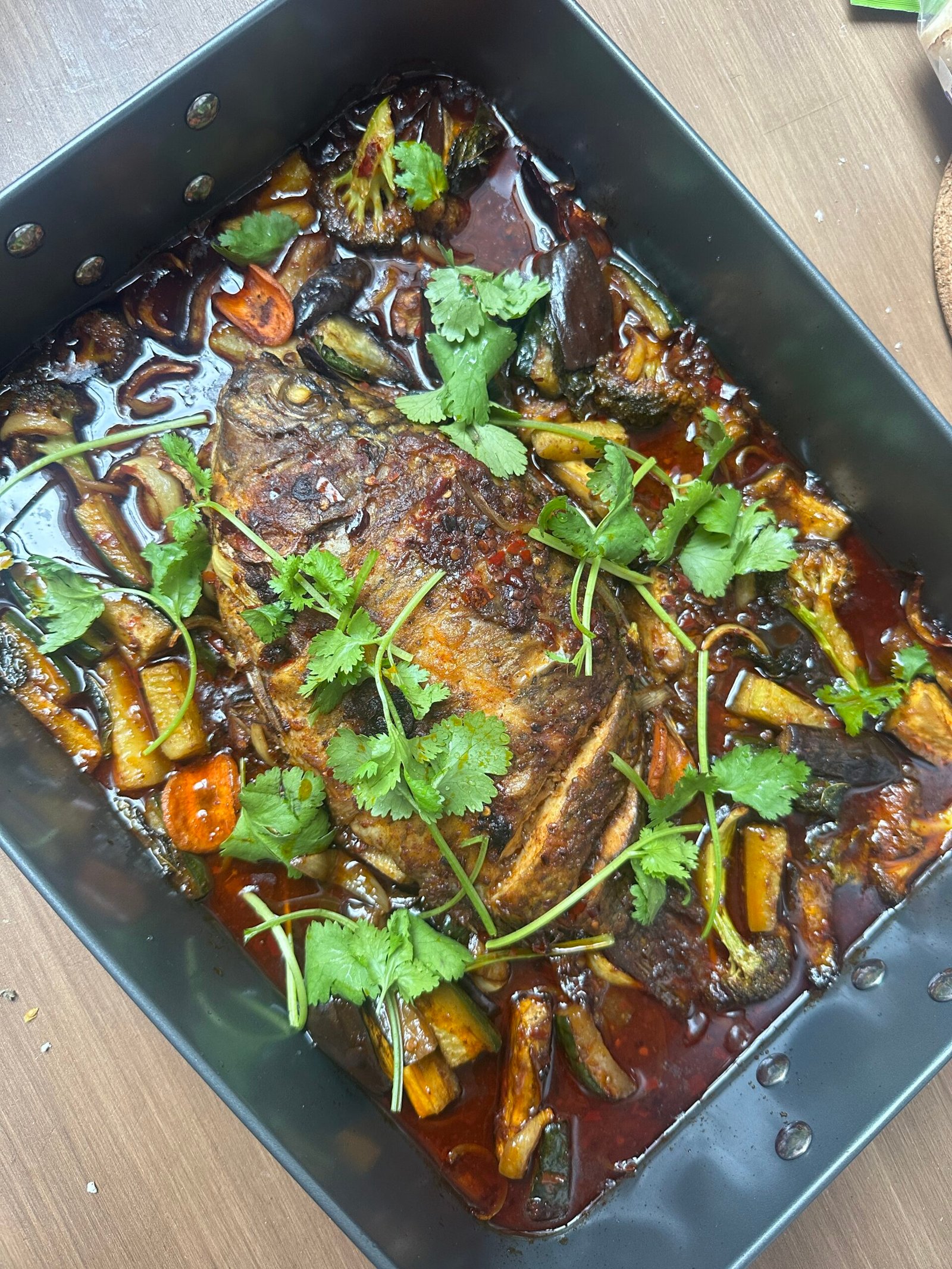 A cooked fish dish topped with fresh cilantro.