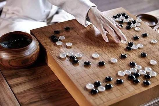 Go board game with black and white stones