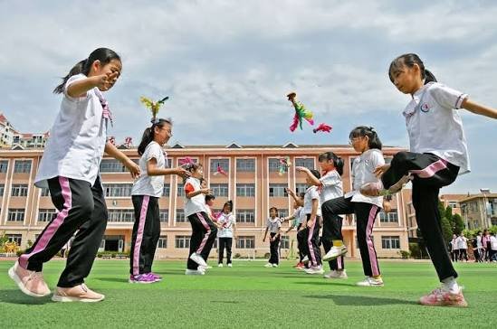People kicking a traditional shuttlecock